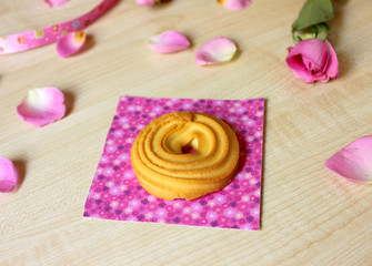 Cookies on the magenta background and pink rose