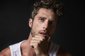 Thoughtful good looking guy in studio, portrait