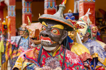 Buddhist lamas dressed in mystical mask dancing Tsam mystery dance in time of Yuru Kabgyat Buddhist...