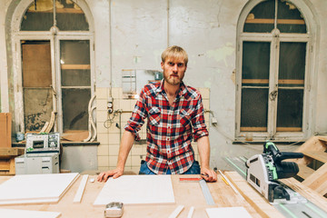 portrait of a self confident carpenter in his workshop