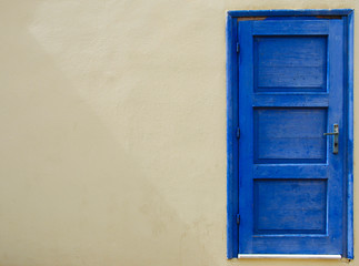 blue seperated door at a wall in Sissi on Crete in Greece