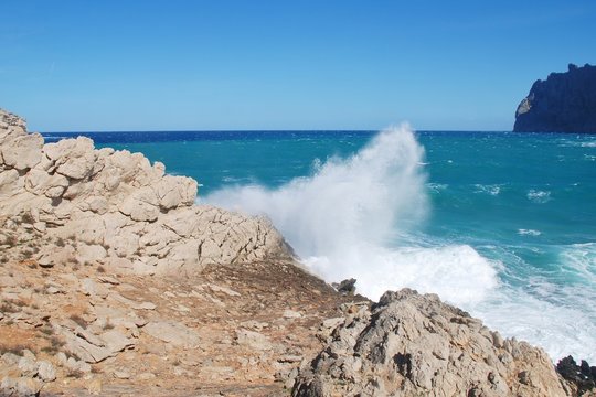 Stormy seas spray over the cliffs by Molin beach at Cala San Vicente on the Spanish island of Majorca.