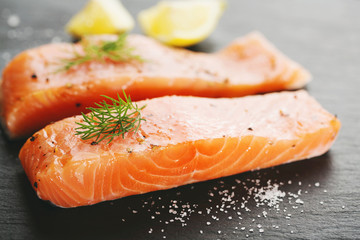 Raw salmon fish on black slate table