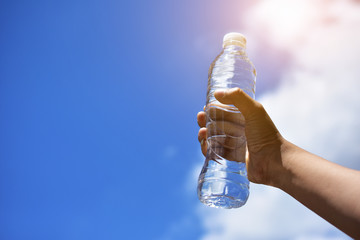 Hand holding drinking water for drink after exercise body sport