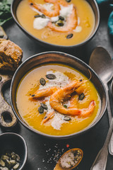Autumn pumpkin creamy soup in bowls