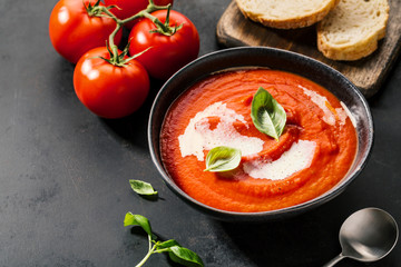 Creamy tomato soup served in bowl