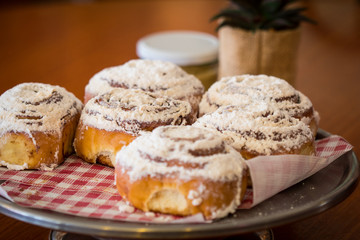 Cinnamon Rolls with Plant on a Table Cafe Setting