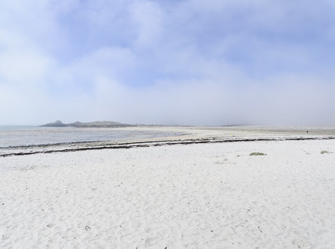 Mist rolling in from the sea across the white sands of  Plage Sainte-Marguerite near Landeda in Brittany.