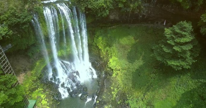 sun rays light foamy waterfall in jungle