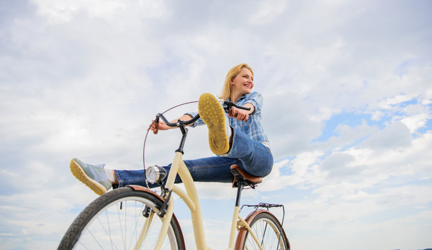Woman feels free while enjoy cycling. Girl rides bicycle sky background. Most satisfying form of self transportation. Carefree and satisfied. Cycling gives you feeling of freedom and independence