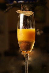 Sorbet mango with chocolate served in tall glass.