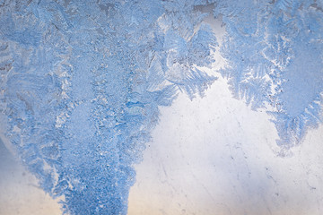 Winter ice pattern on the frozen window. Texture, background for inserting text. New Year theme. Winter. Cold.