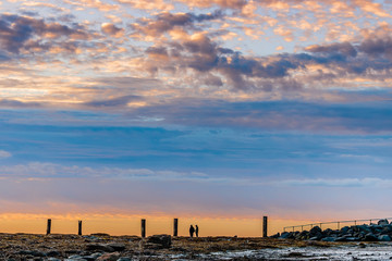Fototapeta na wymiar 2 photographers waiting for sunrise with dramatic sky