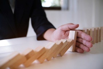 Planning risk and strategy in businessman gambling placing wooden block.Business concept for growth...