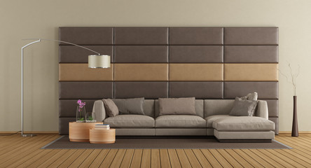 Brown sofa against leather panels
