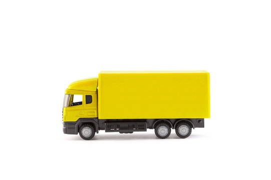 Yellow truck miniature on white background 