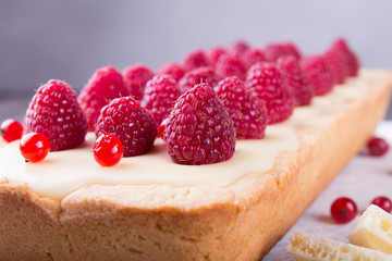 Tarte shortcake with mascarpone, white chocolate and cream served with fresh raspberries and red currant.