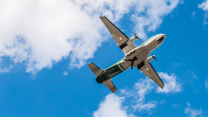 Airplane flying on blue sky. Free space for text