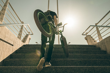 Young man with a bmx bike on the street