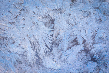 Winter ice pattern on the frozen window. Texture, background for inserting text. New Year theme. Winter. Cold.
