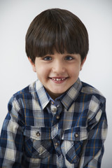 Smiling boy in blue, checked shirt, portrait