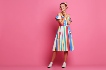 Fashion cool girl posing  on pink background. Young hipster woman, studio shot