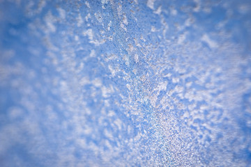 Obraz premium Winter ice pattern on the frozen window. Texture, background for inserting text. New Year theme. Winter. Cold.