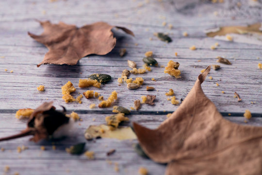 Pumpkin Pie Crumbs On A Wooden Background With Yellow Leafs