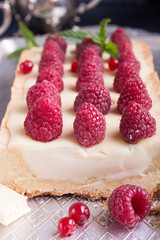 Tarte shortcake with mascarpone, white chocolate and cream served with fresh raspberries and red currant.