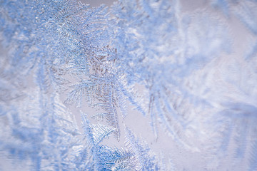Winter ice pattern on the frozen window. Texture, background for inserting text. New Year theme....