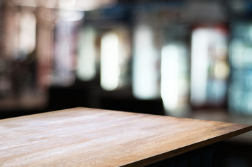 empty wooden table over blur restaurant / coffee shop cafe background