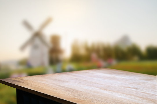 empty wooden table over blur mantage garden background