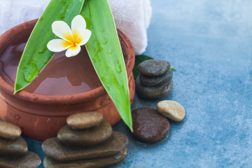 One tropical flower and spa objects and stones for massage salon