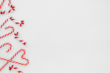 Christmas composition. Christmas frame made of candy cane on white background. Creative flat lay, top view design
