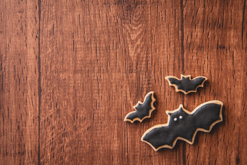 Fresh delicious homemade decorated halloween cookies sweets on dark wooden background, concept of halloween party, copy space(text space), top view, blank for text.