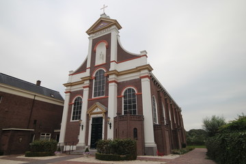 Fototapeta na wymiar Catholic church Saint Barnabas from 1864 in the village of Haastrecht in the Krimpernerwaard in the Netherlands