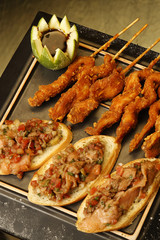 Fried and breaded chicken strips accompanied by bread with pumpkin sauce.