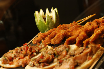Fried and breaded chicken strips accompanied by bread with pumpkin sauce.