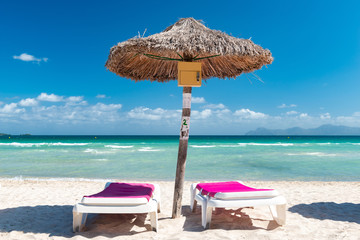 Parasol with two sunbeds on the sandy beach  |  9568