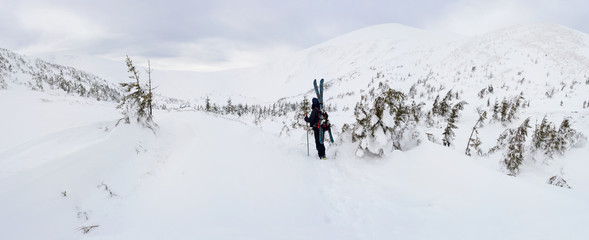 Alpine touring skier in winter mountains.