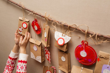 child's hands holding a gift from advent calendar