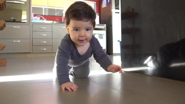 Adorable baby boy funny crawls in the floor