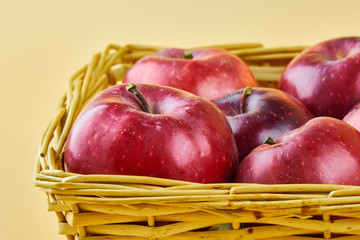 Tasty red apples in basket close up