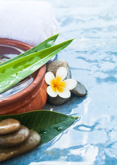 Spa objects for massage therapy on blue background.