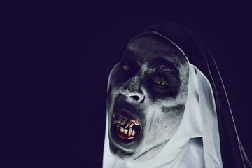 frightening evil nun with bloody teeth