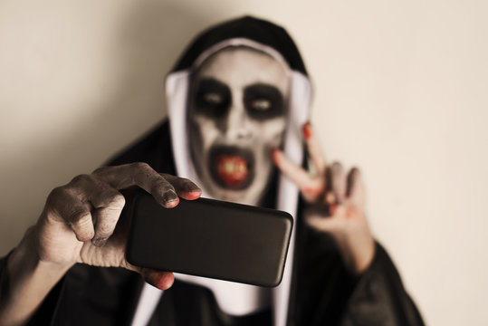 frightening evil nun taking a selfie