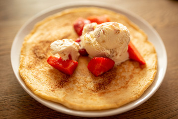 Pancake with strawberries and ice cream