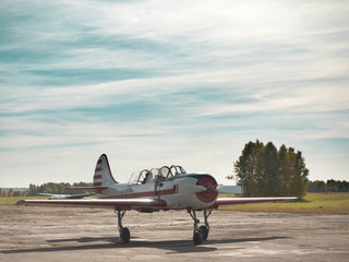 View of airplane on grassy airfield close up; classic plane taxiing to takeoff on runway; training...