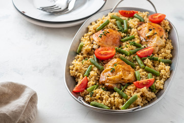 Grilled chicken thighs with bulgur, asparagus beans and tomatoes. Delicious lunch.