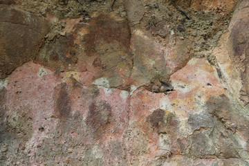 Closeup of the surface of pink mountainous rock. The natural art background.